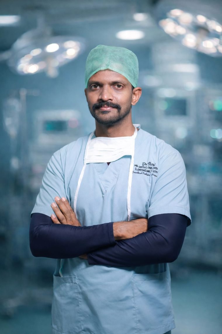 Dr. Vetri Chelvan in surgical scrubs inside the operating theatre at Unittas Multispeciality Hospital, Chennai